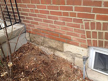 wet spot on bricks/foundation of 85 year old home - why?