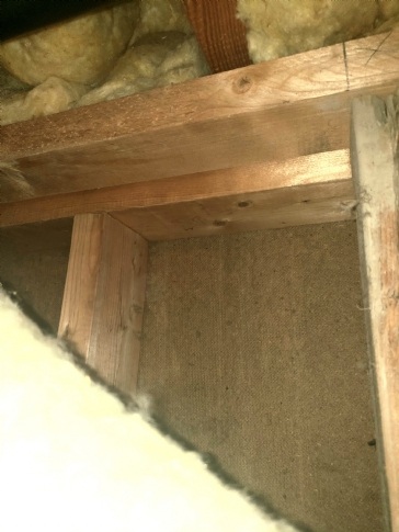 Fibreboard inside above-grade basement walls...how do I insulate over this?