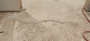 Self-leveling concrete not adhering to wood floor