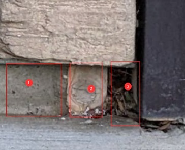 Exposed Wood & Holes by Garage Door