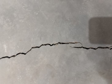 Two big cracks in the basement floor from wall to wall