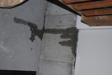 Determine water leak into and over garage foundation wall after rain