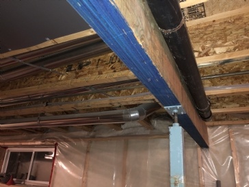 Framing around main beam with plumbing pipe in the way
