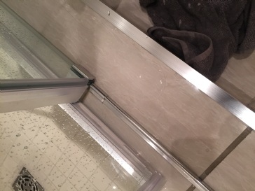 Leak from corner of shower pan behind and below pan