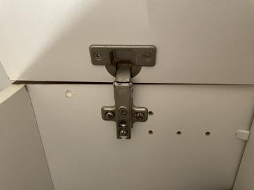 Repairing a hinge in a bathroom cabinet 