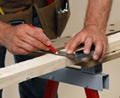 Framing carpenter measuring a cut
