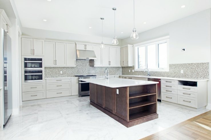 kitchen with white cabinets and dark brown centre island