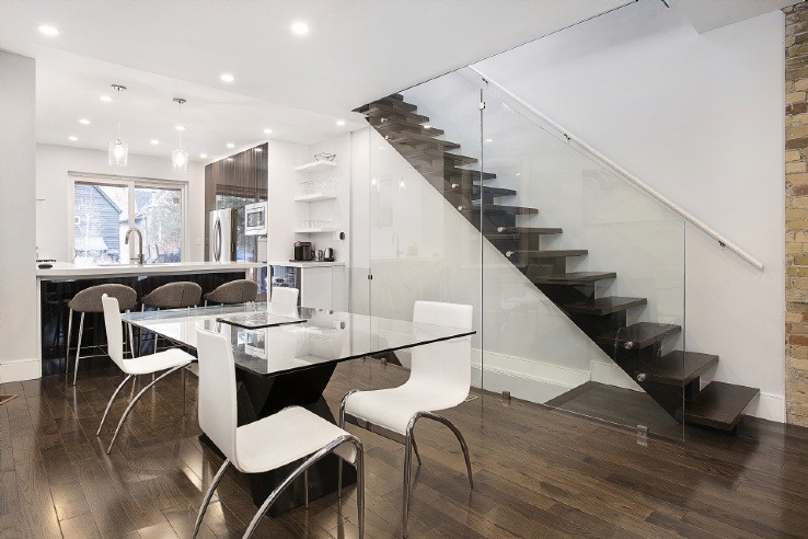 open concept main floor with glass railing stairs