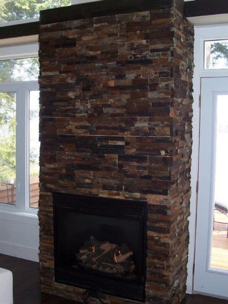 Gas fireplace with floor to ceiling slate field stone