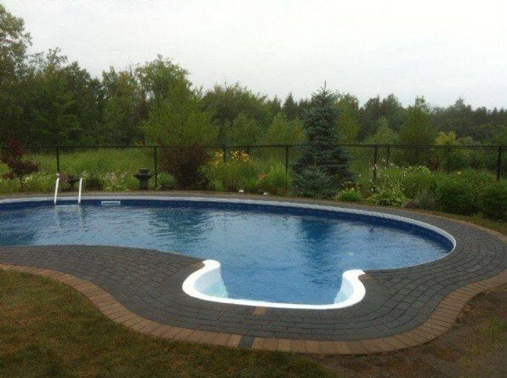 Kidney shaped pool with unlock hollandstone pool deck