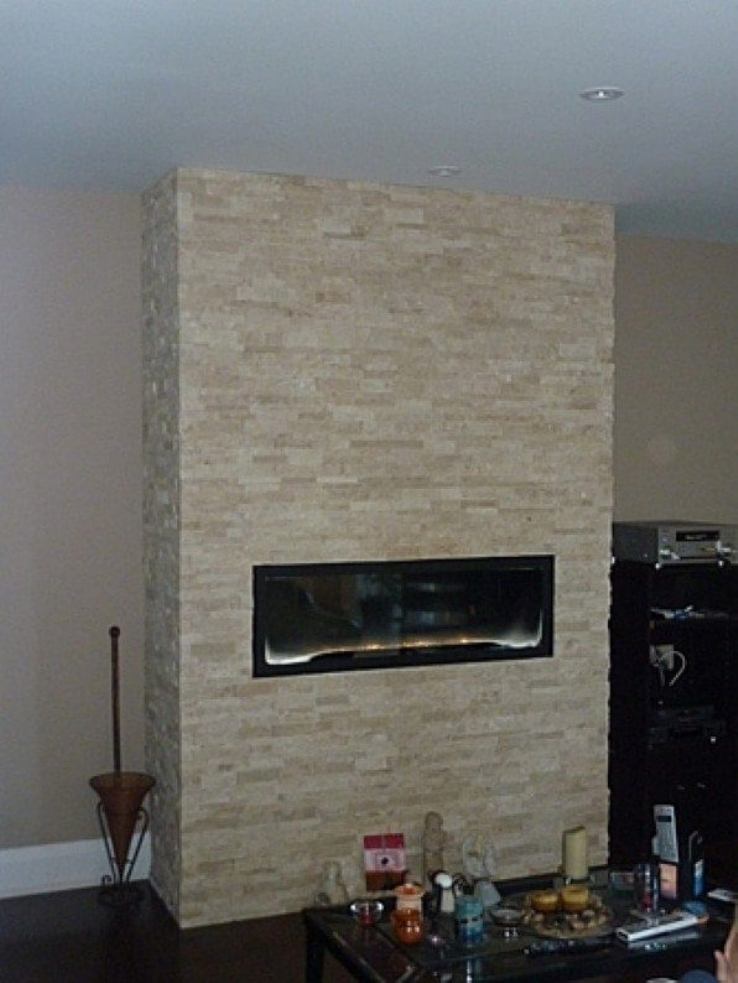 Linear gas fireplace with stone surround