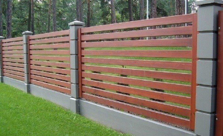 Custom hardwood fence with concrete posts